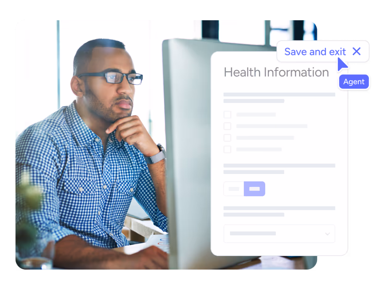 A guys sitting in front of a computer