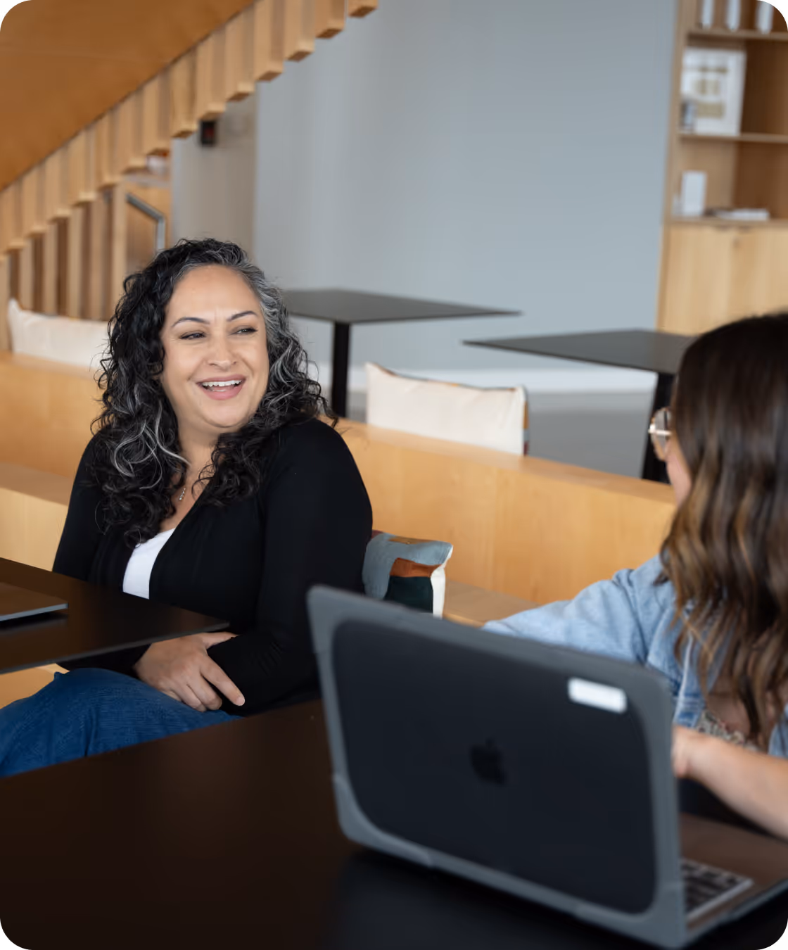 Employees conversing in the Dallas office. 
