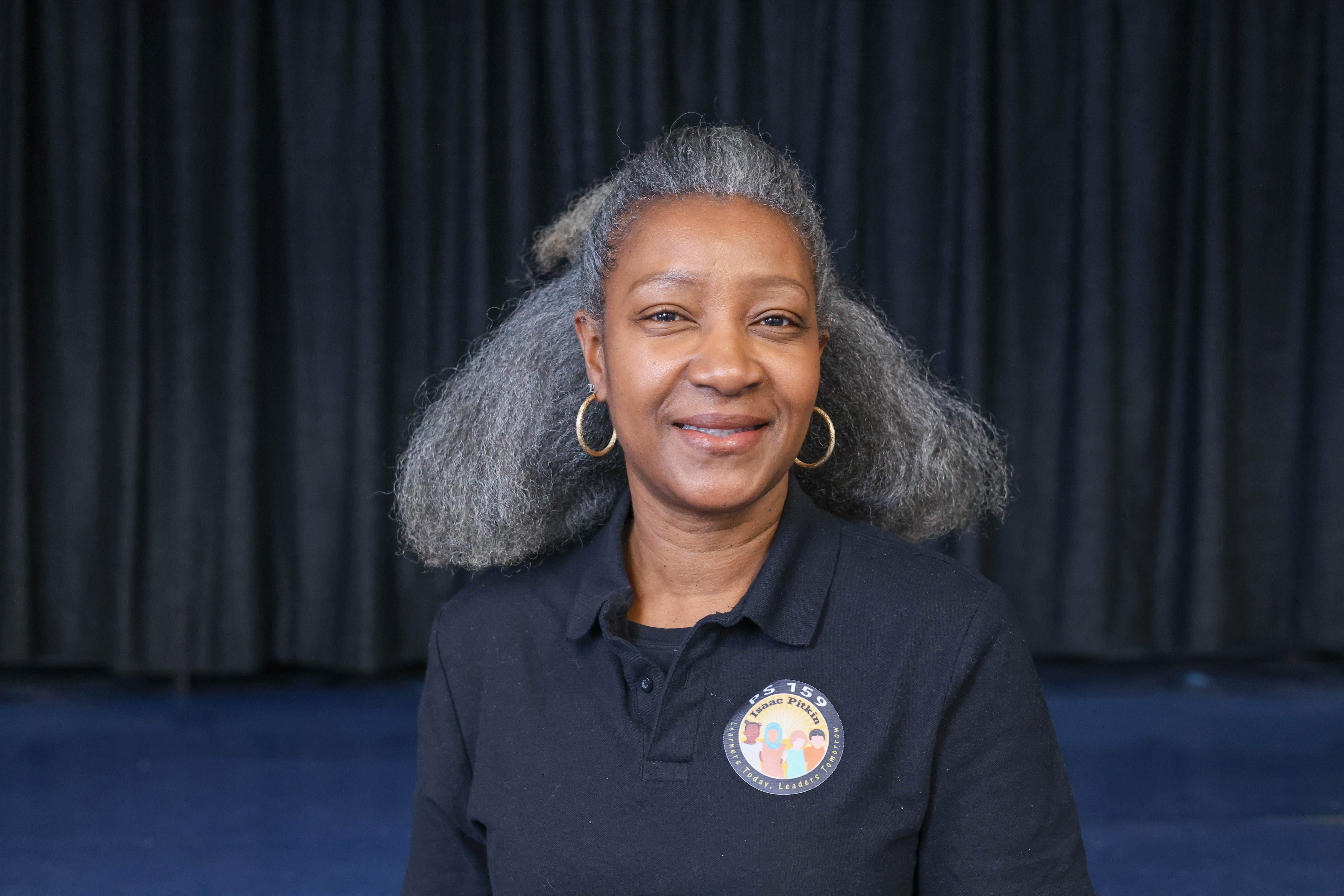 Trecia Grant PS 159 staff member smiling in school polo