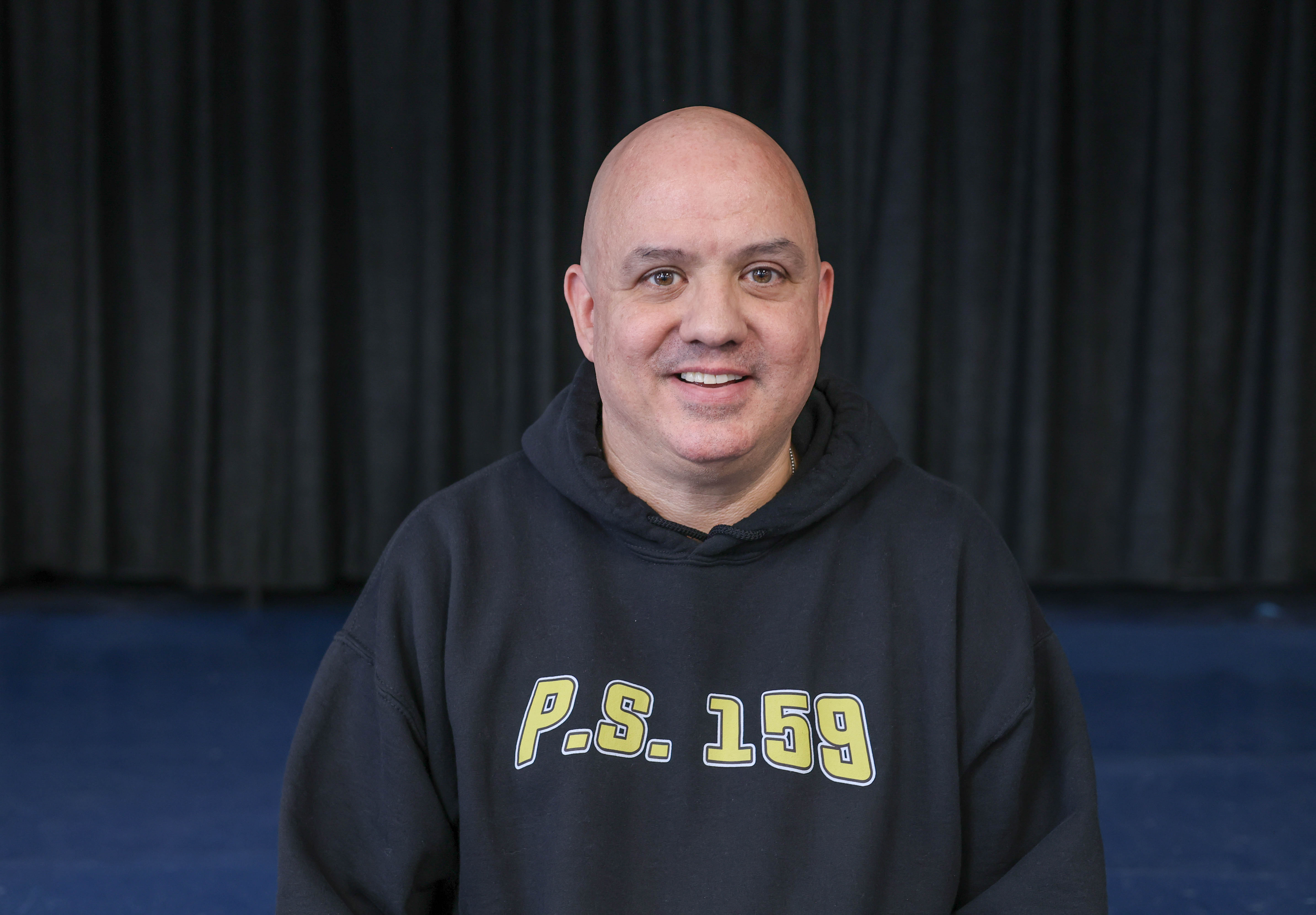 D Scolaro smiling in a PS 159 school hoodie