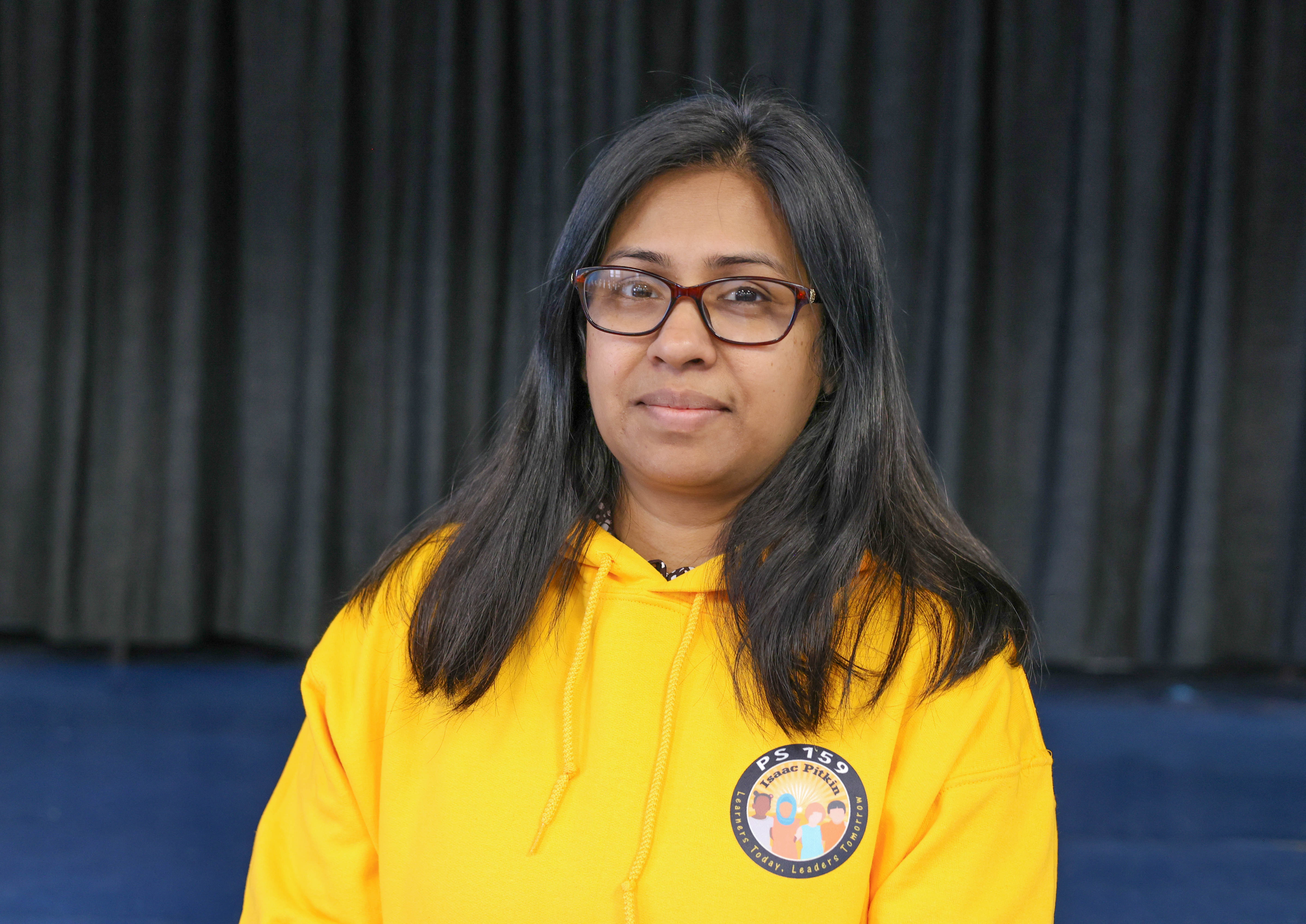 Sabiha Sultana staff member wearing PS 159 yellow hoodie