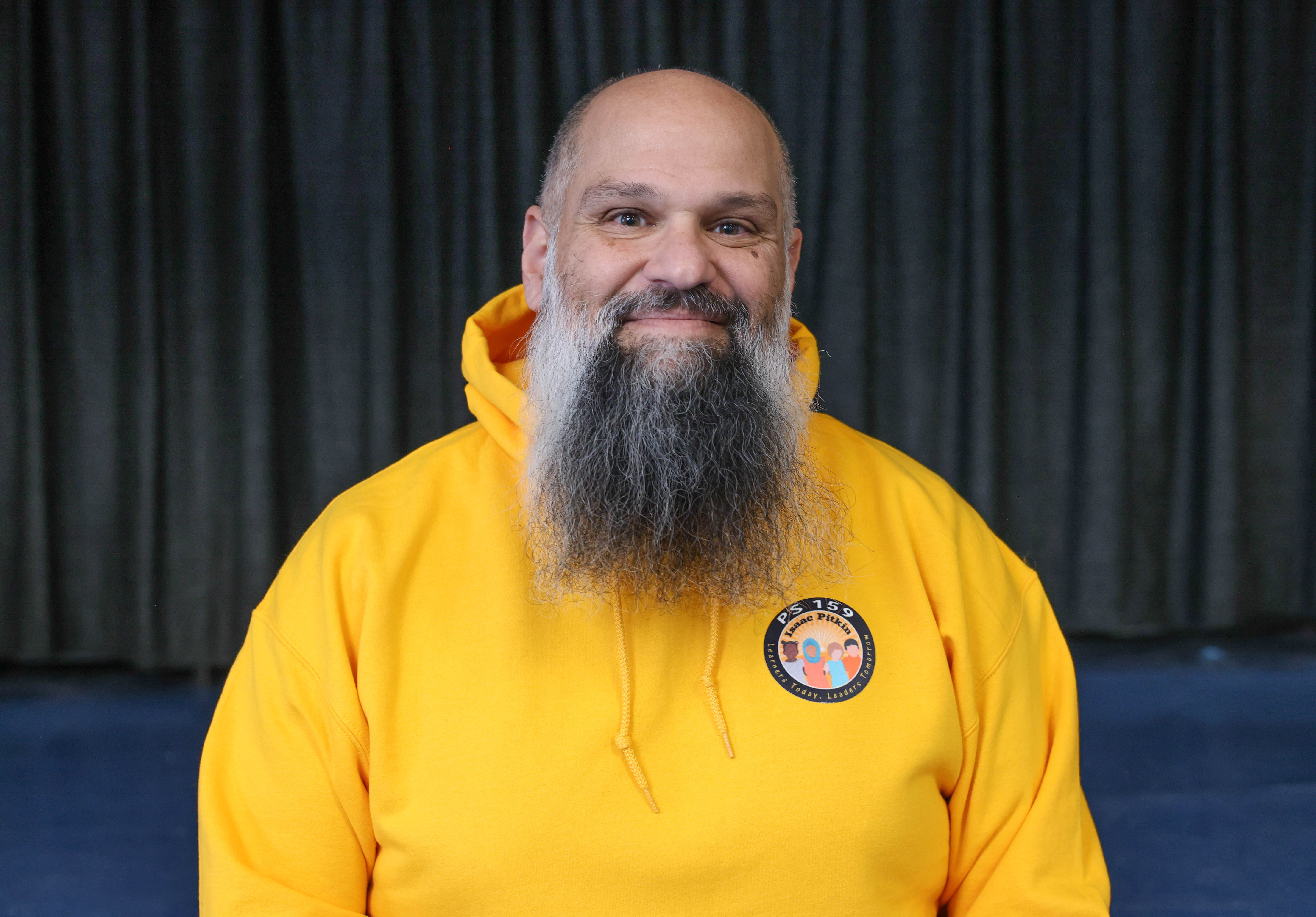PS 159 staff member Nick Grammenos smiling in school hoodie