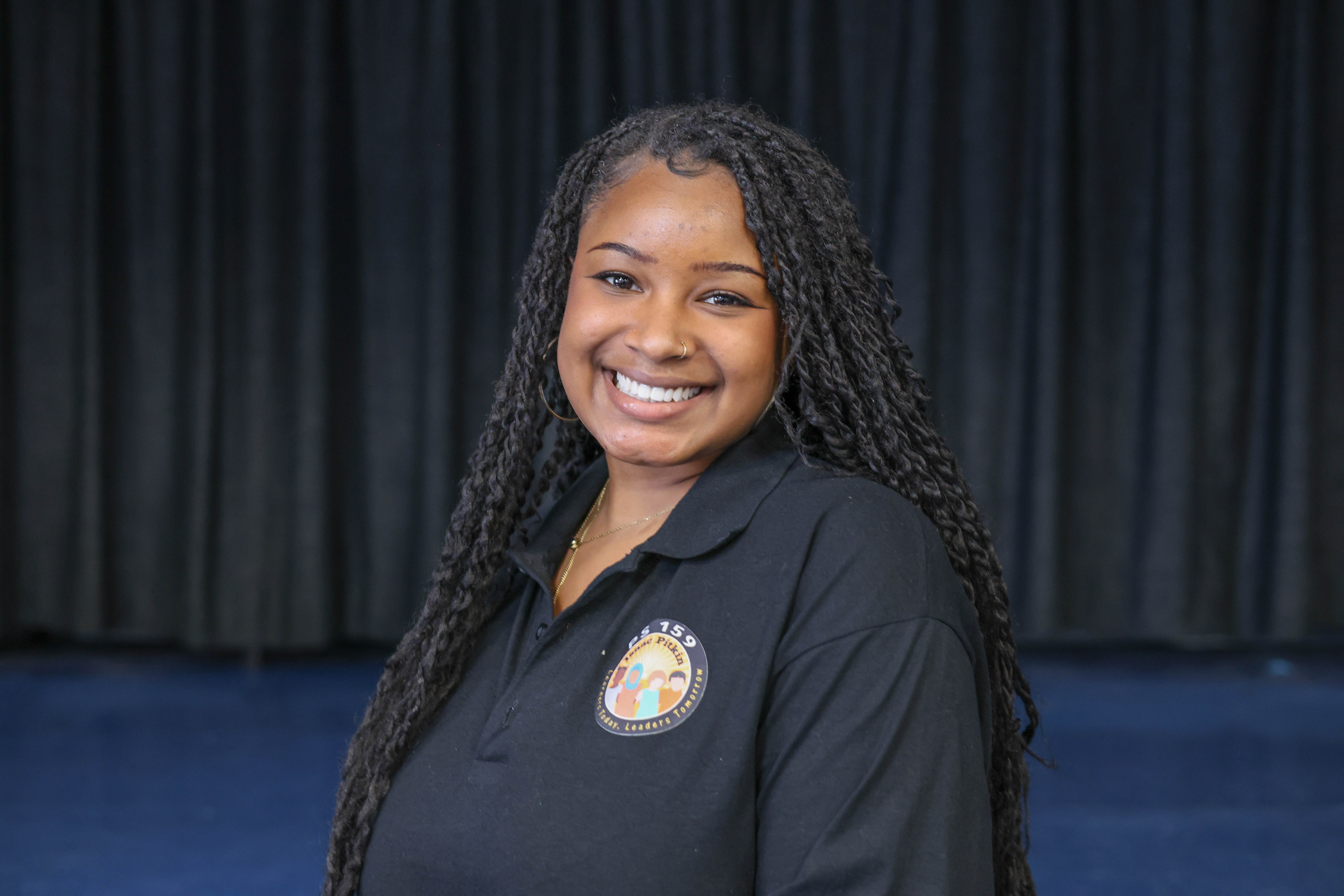 Starasia Darnley staff member wearing PS 159 black polo