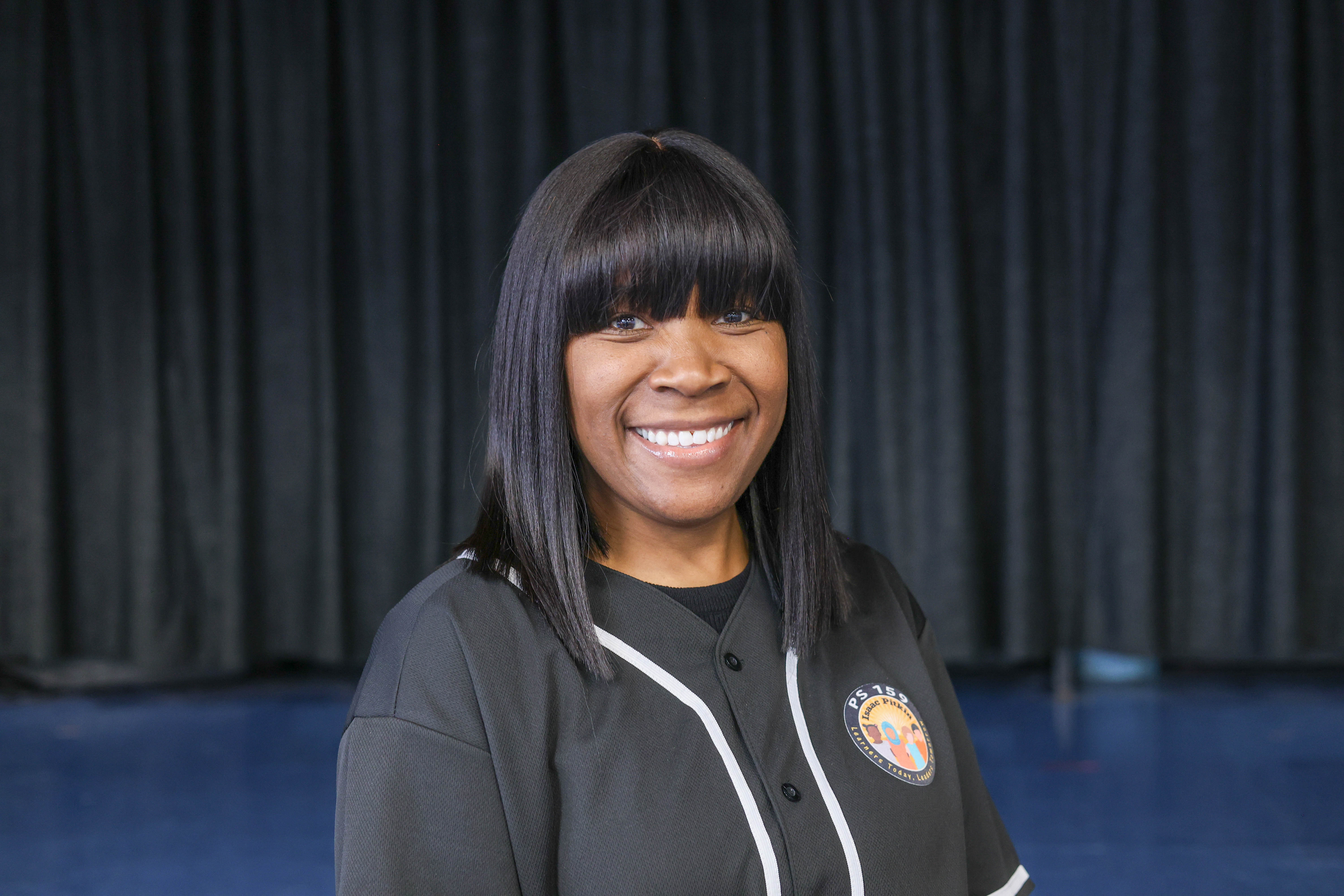 Merissa Davis smiling in PS 159 school staff jacket