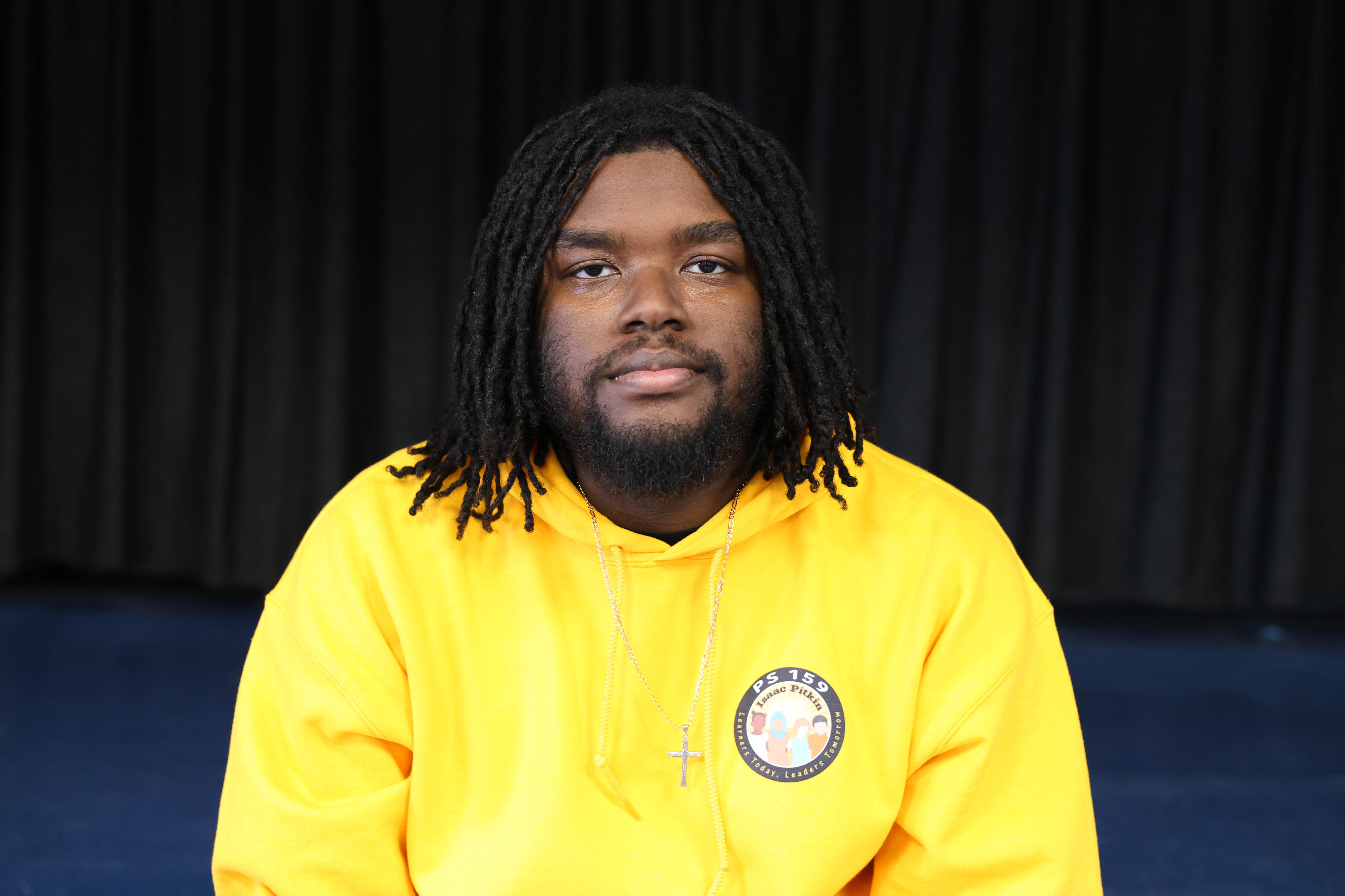 Jaden Billips staff member wearing a PS 159 yellow hoodie