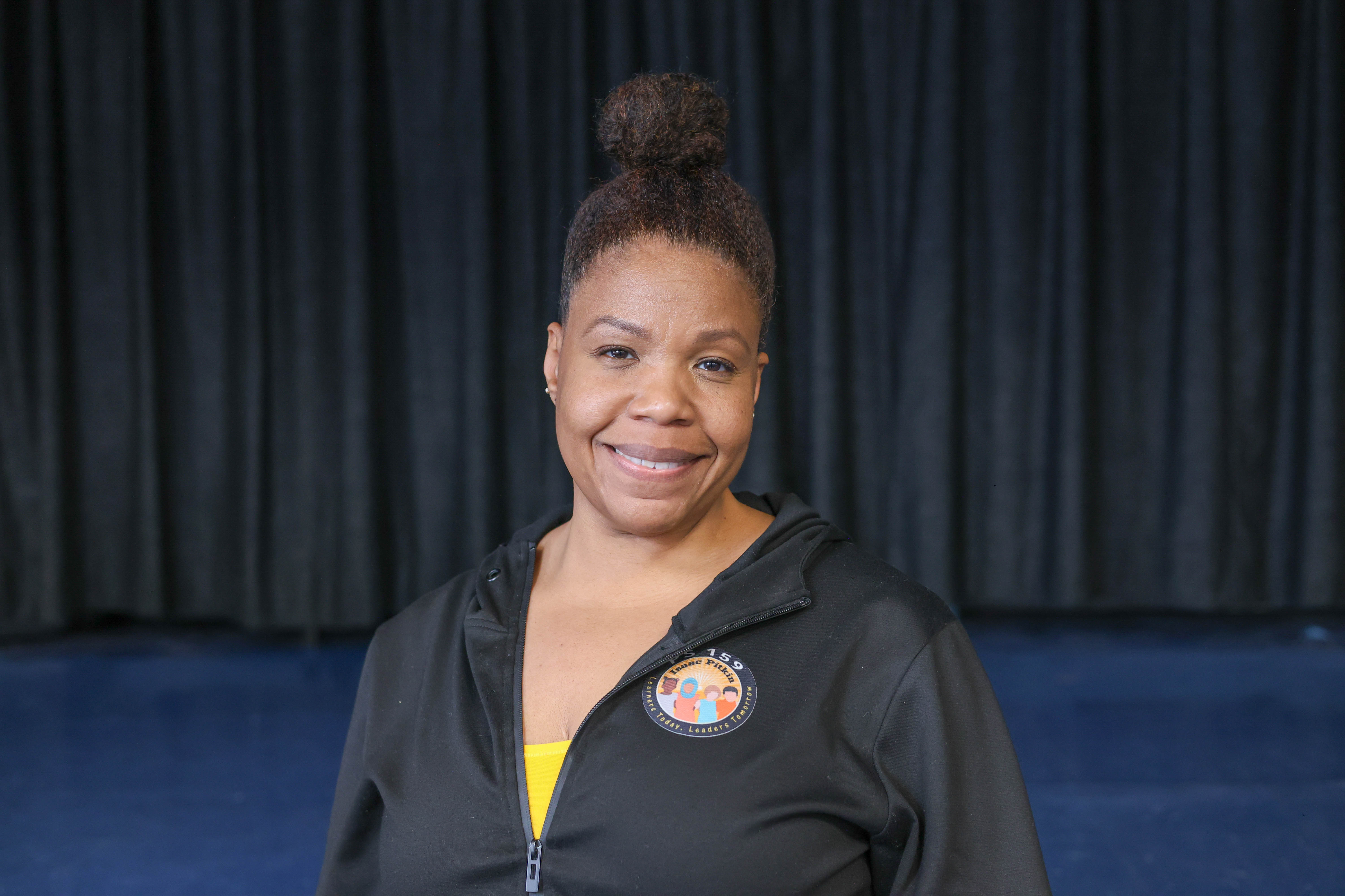 Keisha Smart smiling in school branded black jacket