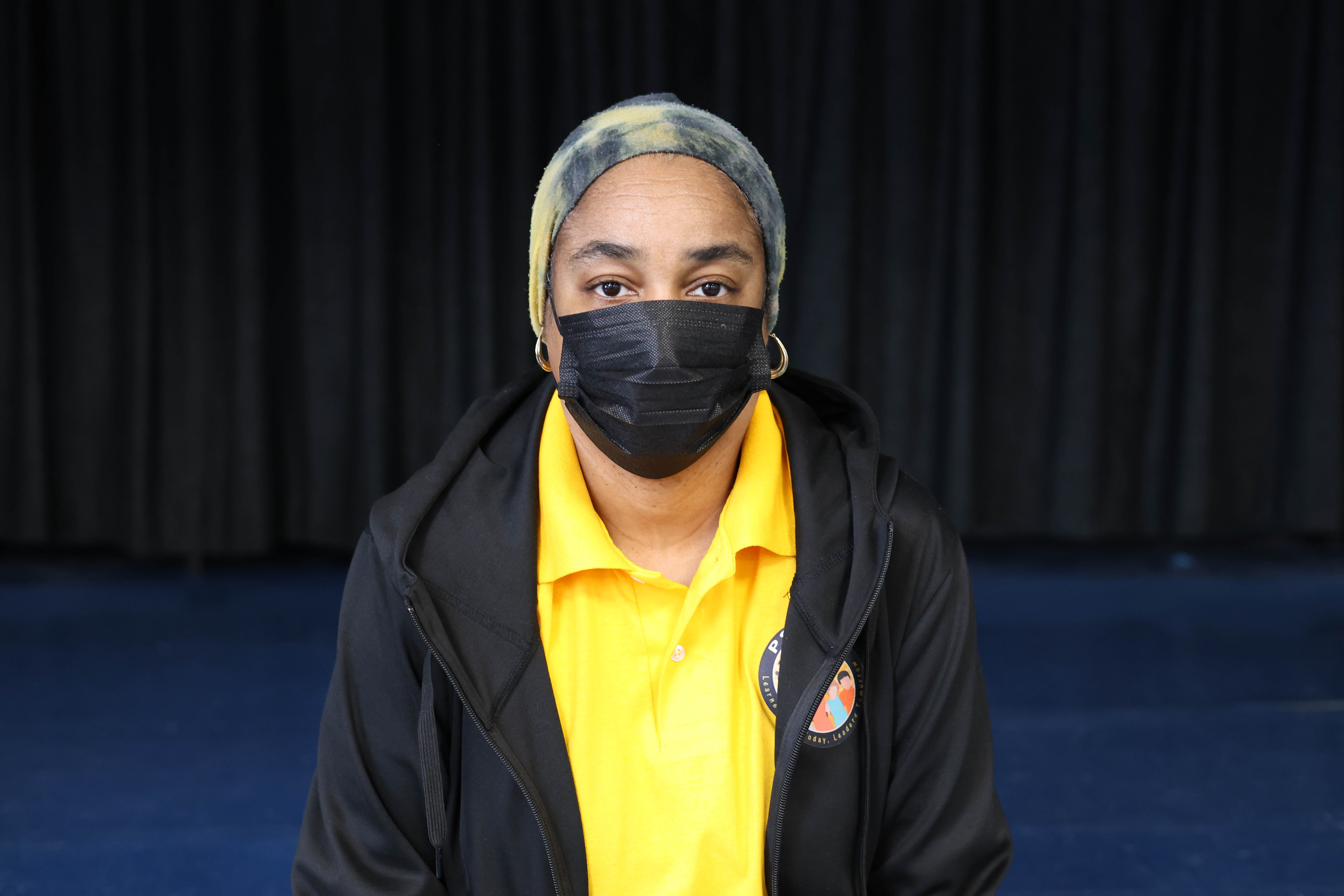 Nicole Wilson staff member wearing yellow polo and black jacket