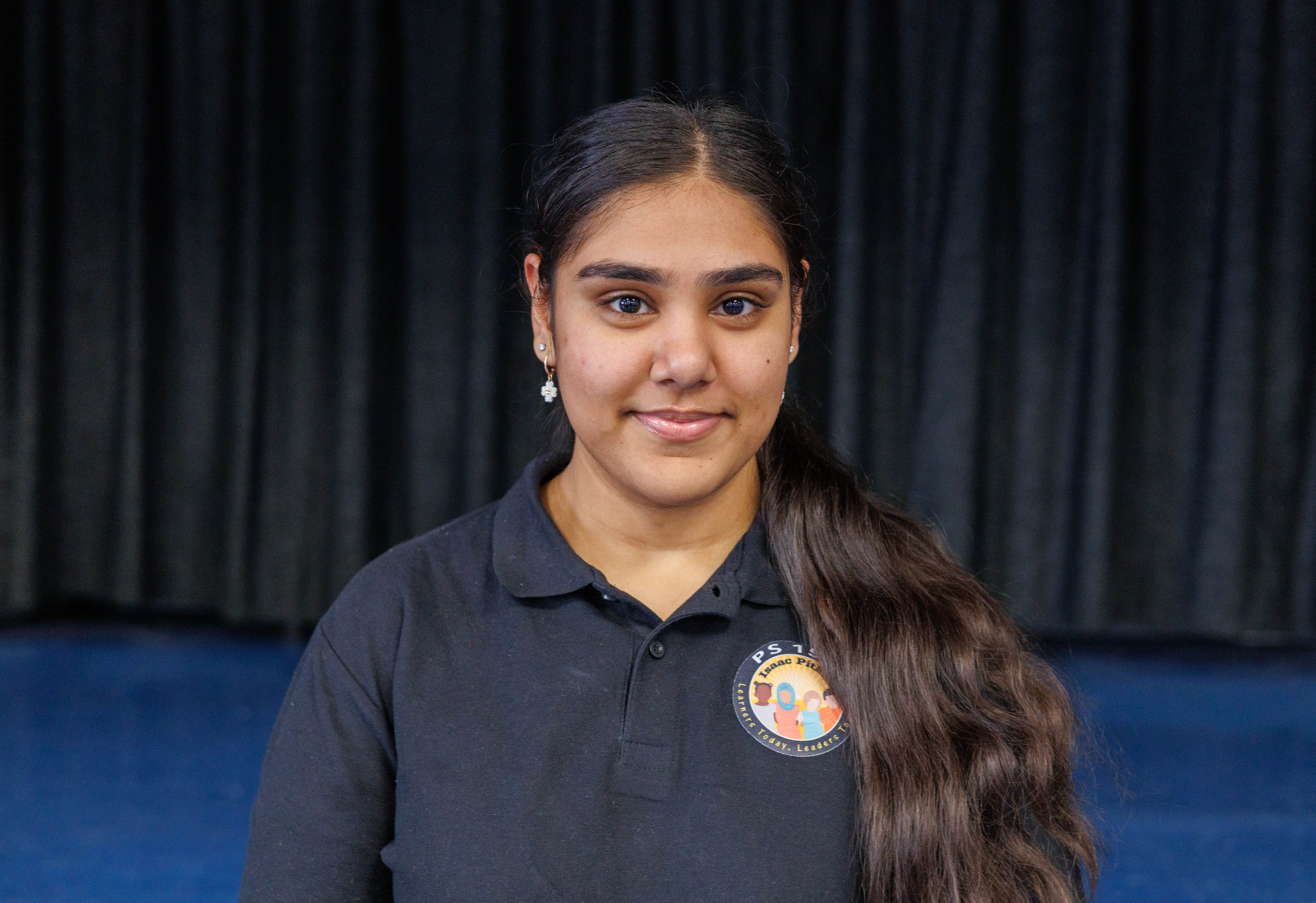 Shemiza Basdeo smiling in PS 159 school uniform