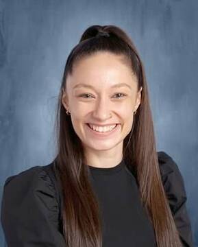 Staff photo of A. Rosado smiling in professional attire