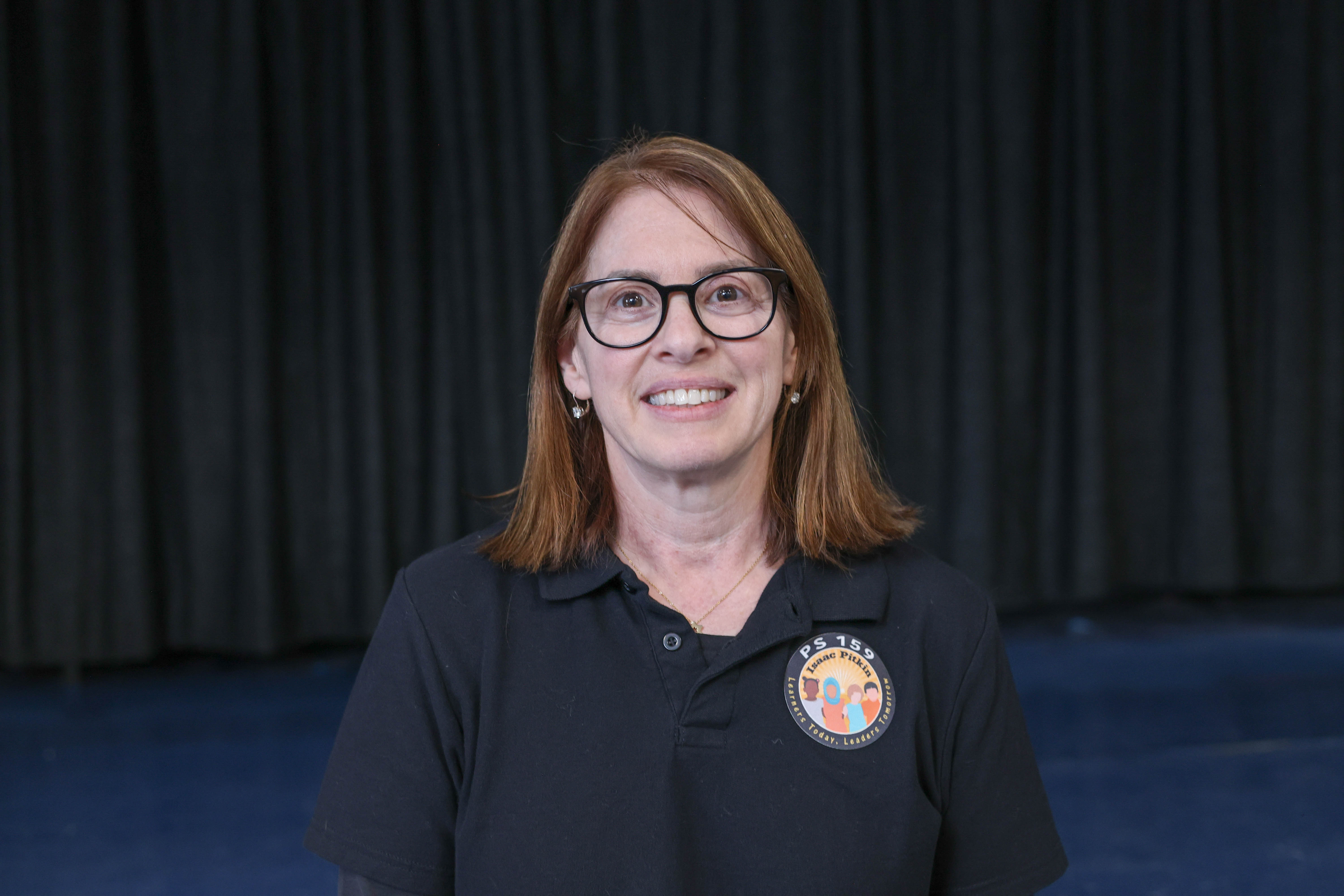 Heidi Grossman PS 159 staff member smiling in school polo shirt