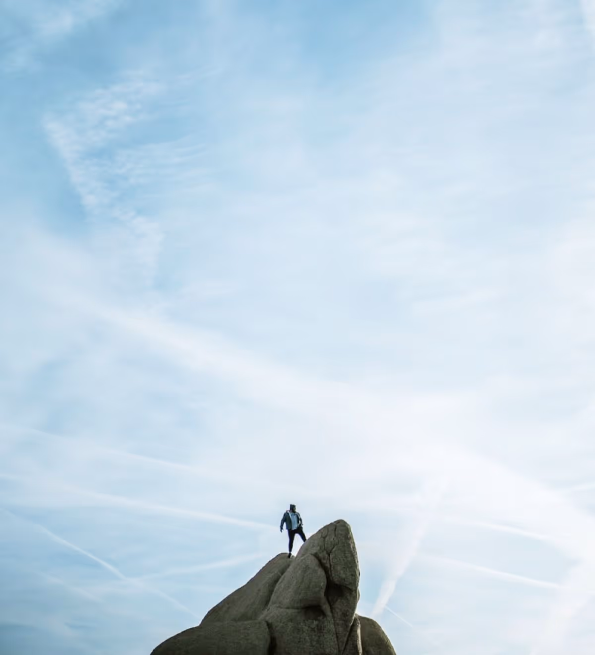 Person standing on top of a rock