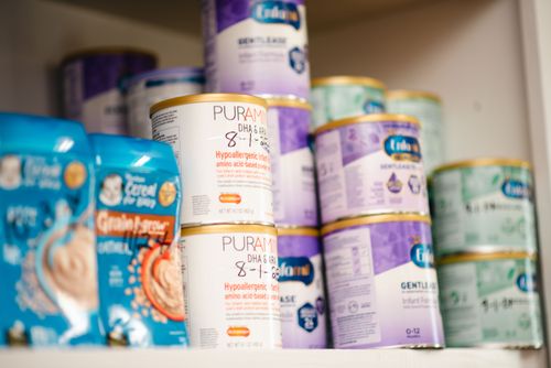 Baby formula stacked on a shelf