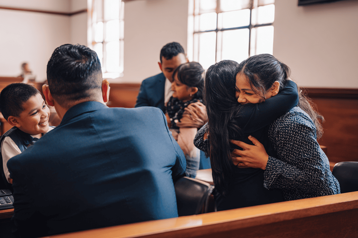 family hugging in court