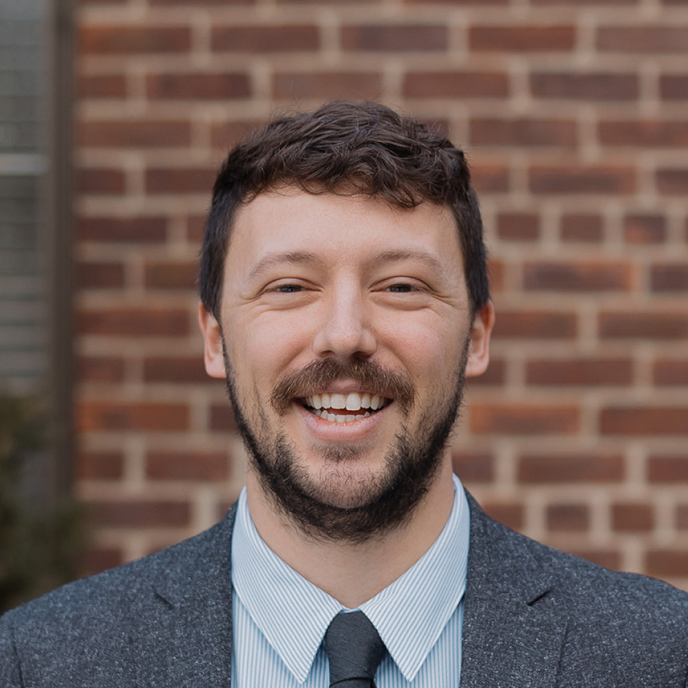 Pastor Cade McDonald headshot in front of North Shore Baptist Church in Bayside, NY