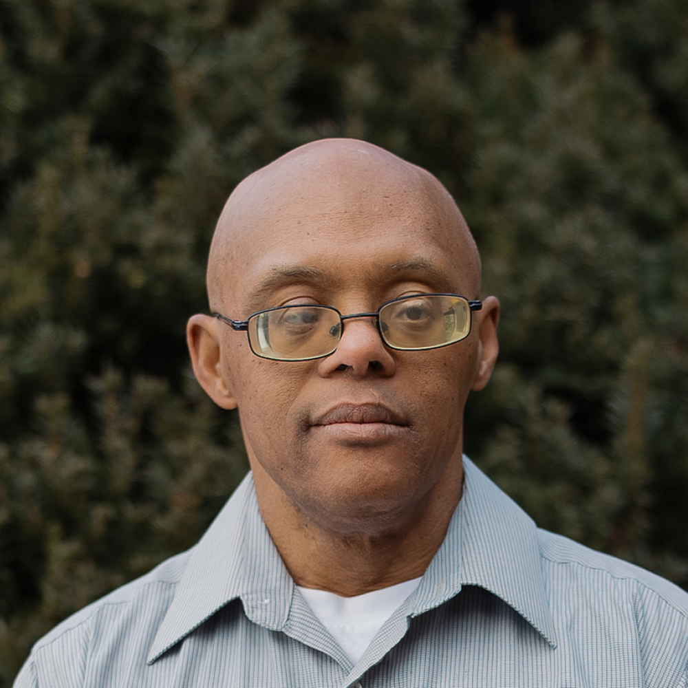 Staff member Jerry Rene headshot in front of North Shore Baptist Church in Bayside, NY