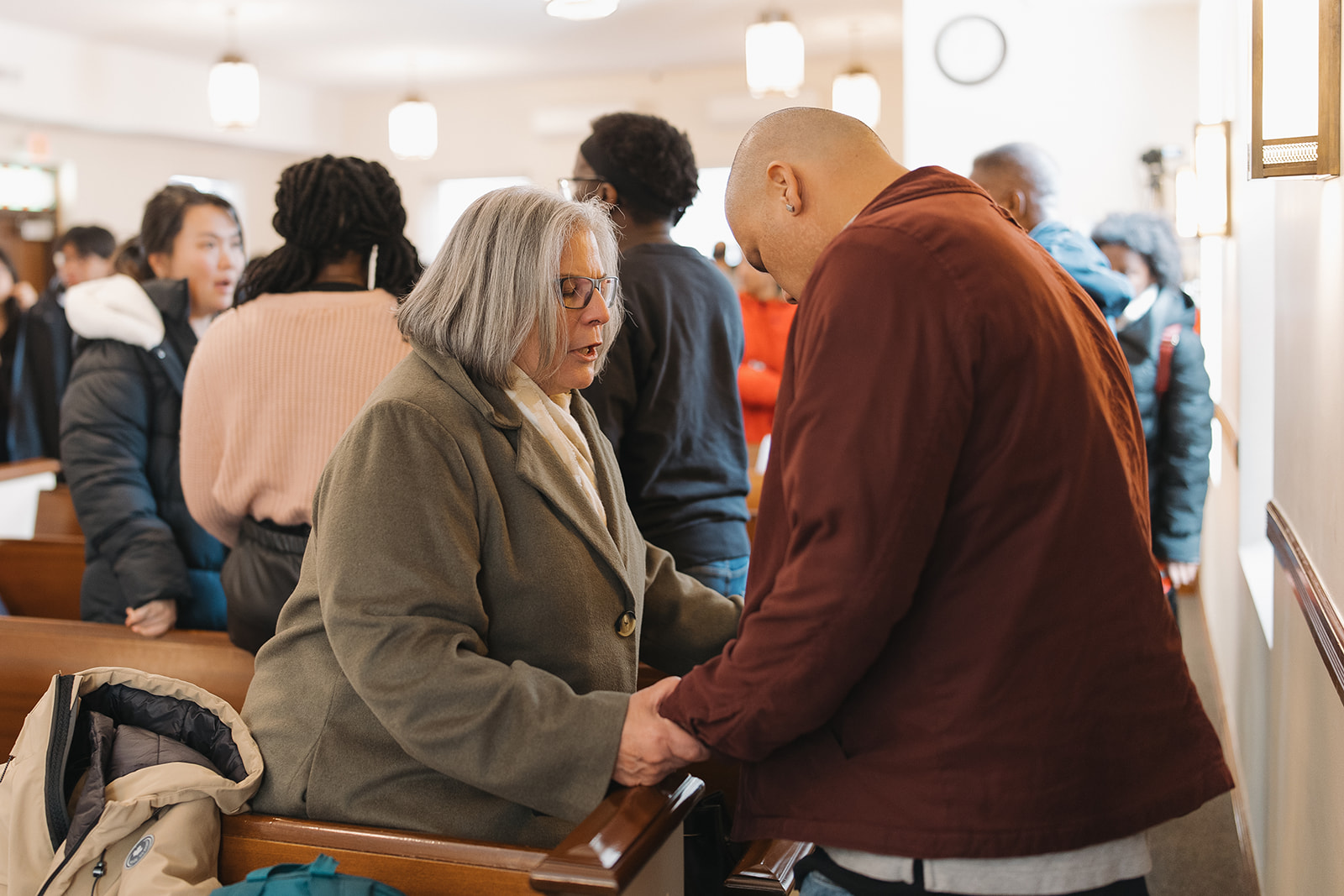 Church members praying for one another at North Shore Baptist Church in Bayside, NY