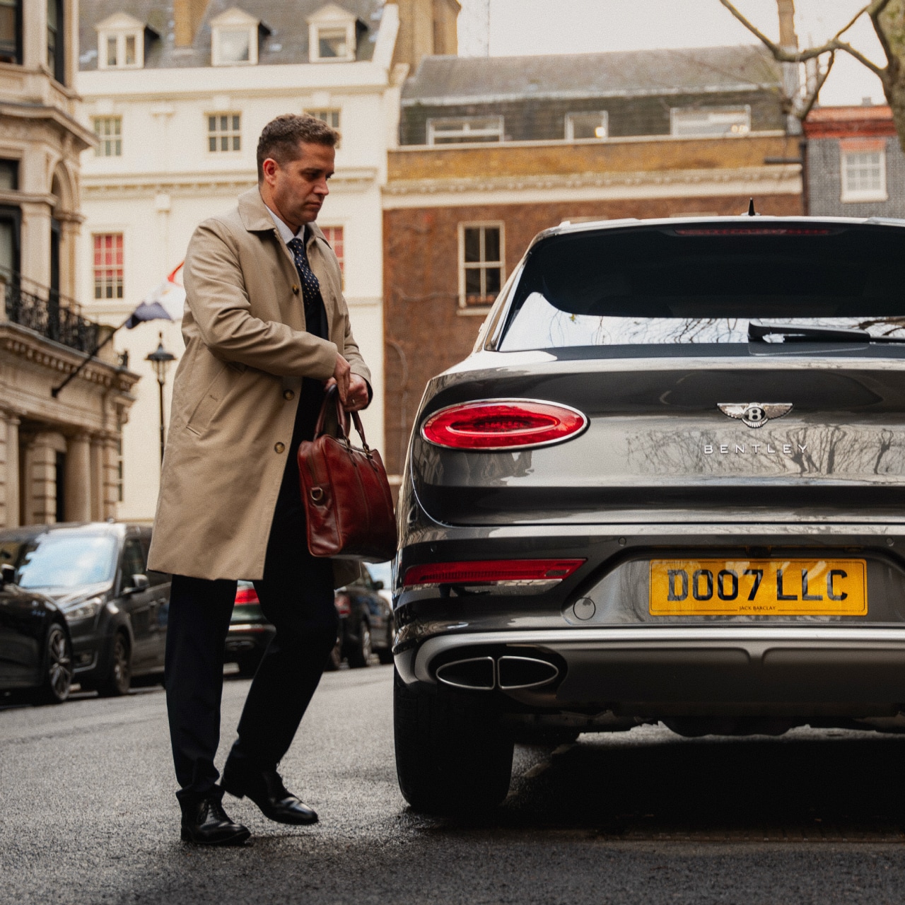Private chauffeur assisting family with luggage during luxury estate transfer.