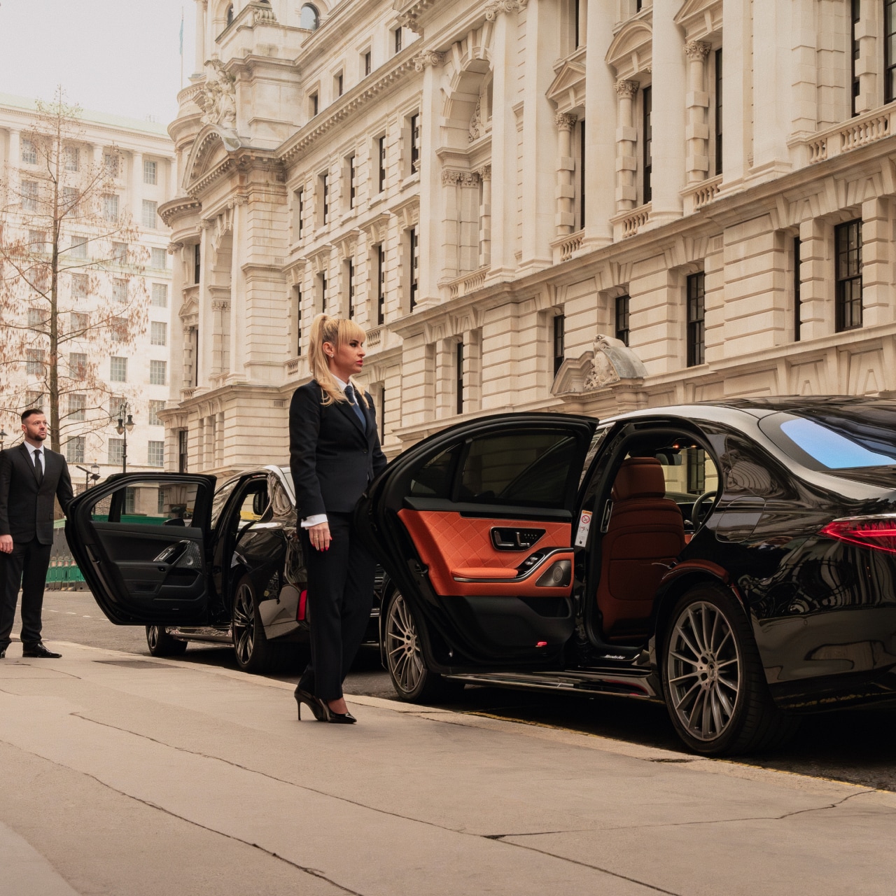 Luxury corporate chauffeur driving executive in premium vehicle for board-level transport