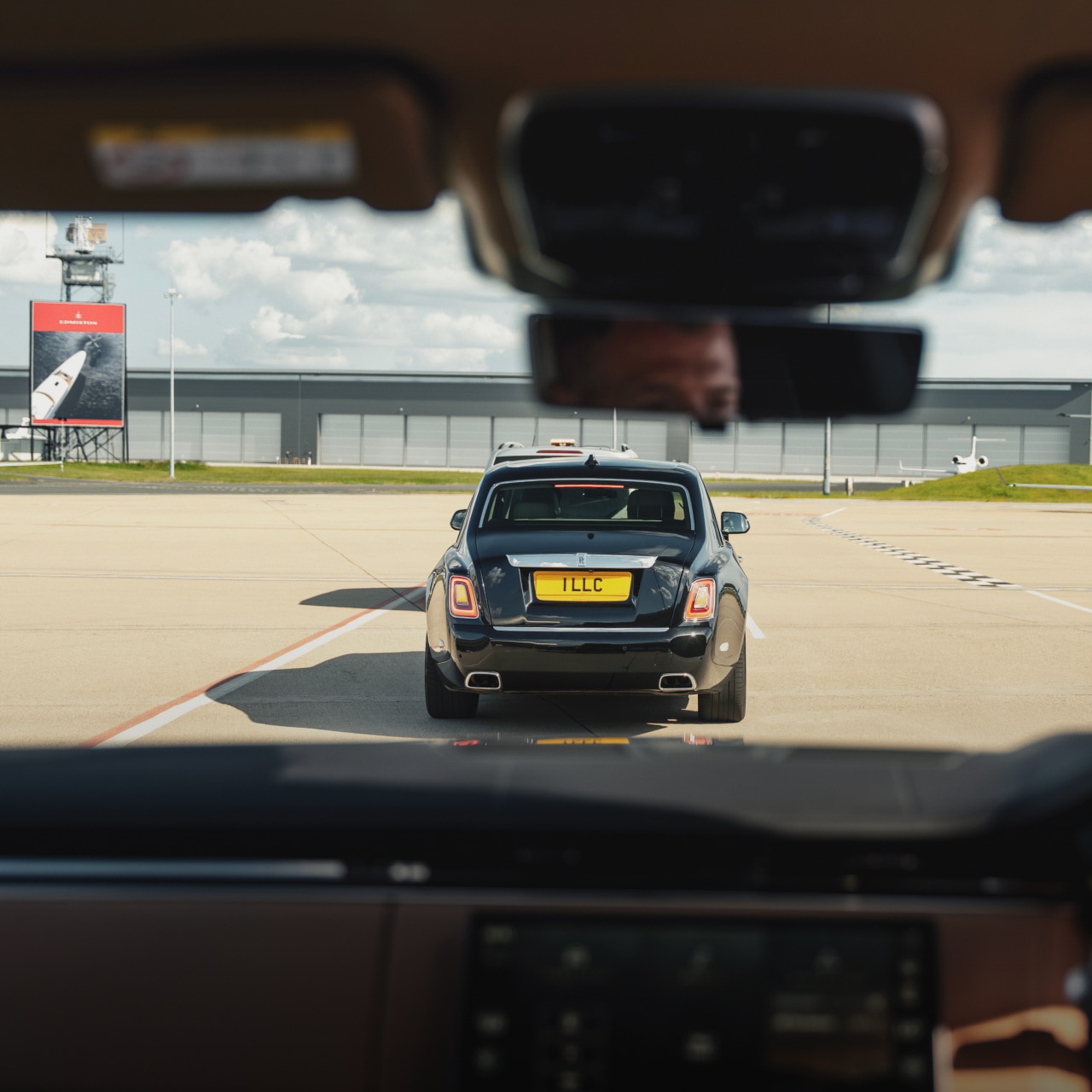 Elite Chauffeur in luxury vehicle offering high-touch service with privacy and discretion.