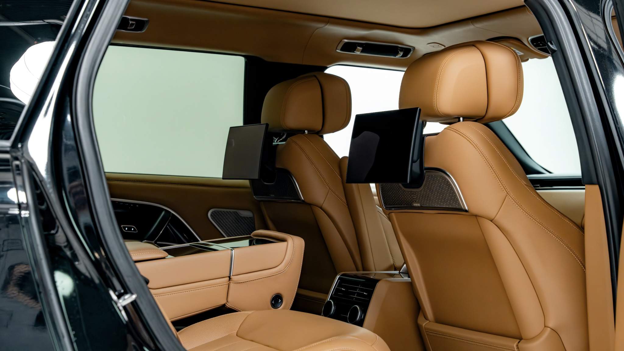 Luxurious rear passenger seating inside the Range Rover Autobiography, photographed from the back door to showcase comfort and legroom