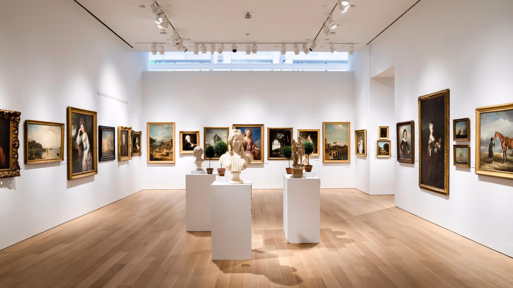 Interior view of Christie’s London gallery displaying Old Master paintings and sculptures.