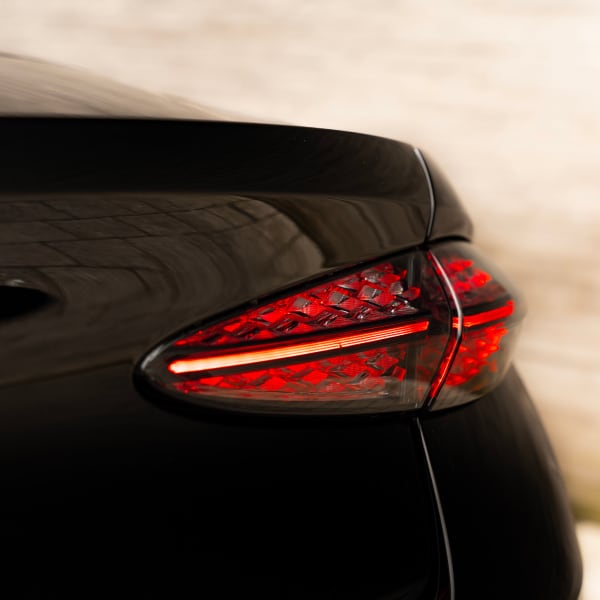 Bentley Continental GTC at night, illuminated by city lights for a stunning visual