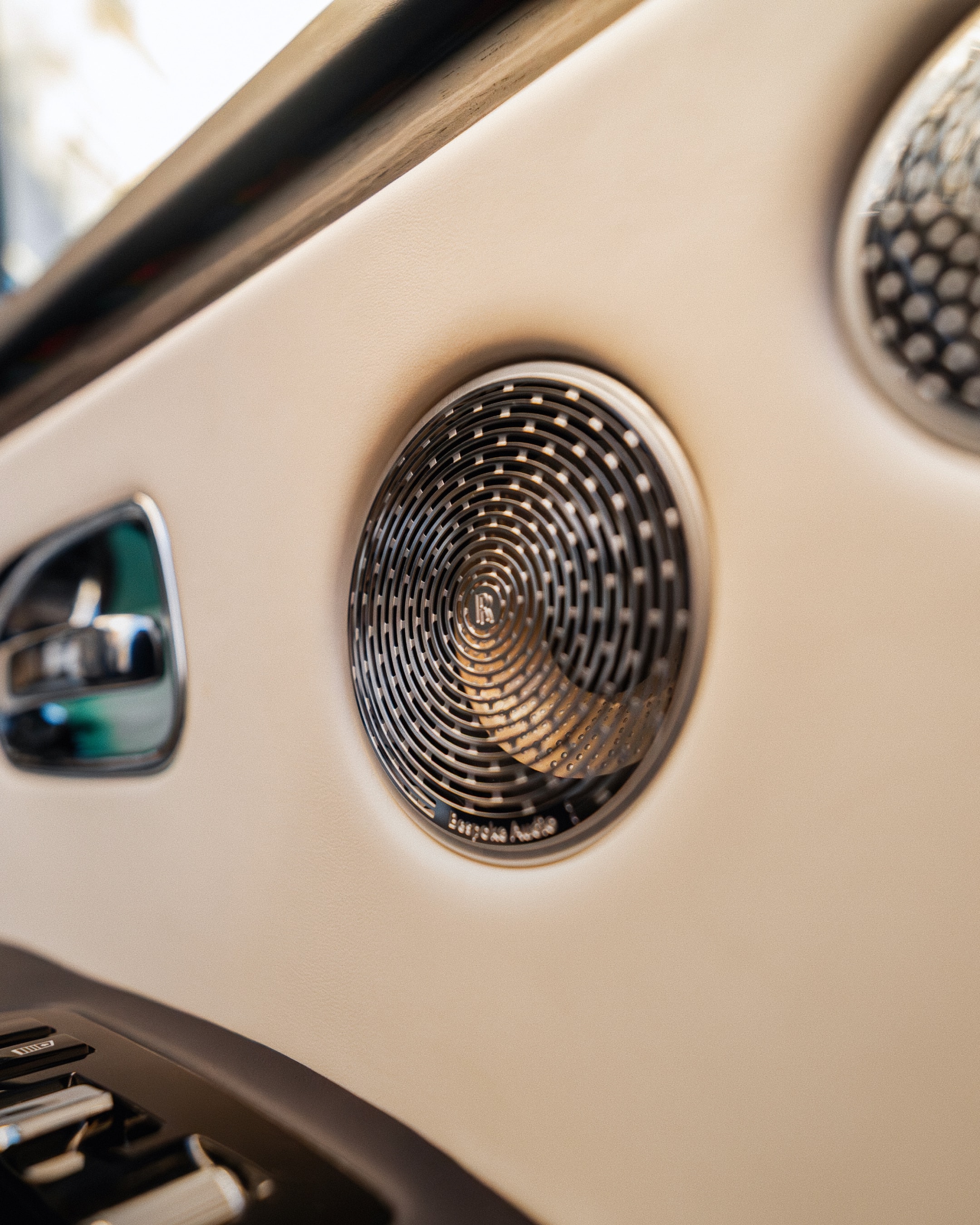 Side view of the LLC Rolls-Royce Ghost showcasing its long, commanding silhouette and high-gloss wheel detailing on a quiet, affluent London street.