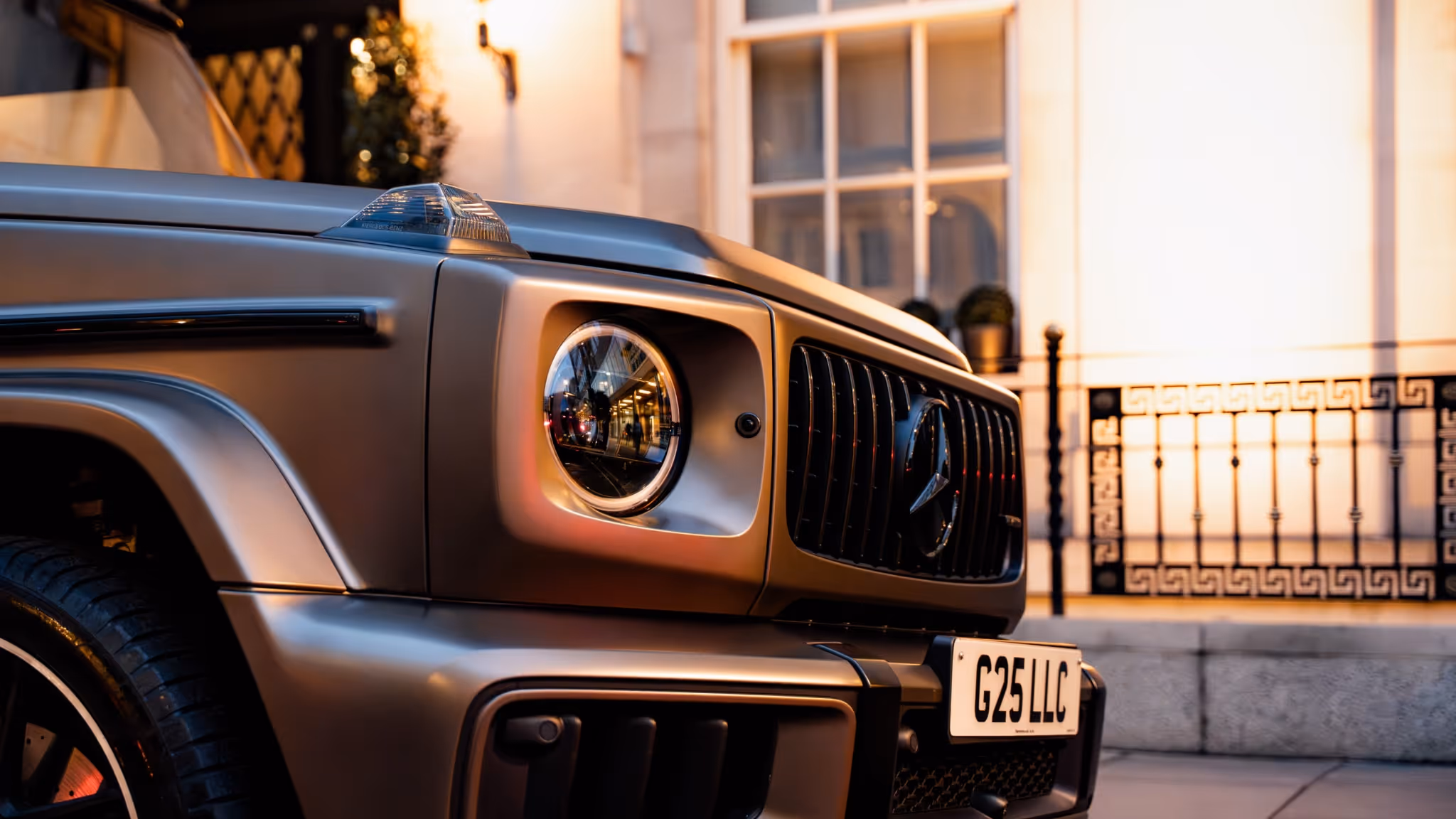 Executive chauffeur-driven Mercedes G-Class arriving outside a Mayfair townhouse, delivering discreet VIP transport, self-drive experience.