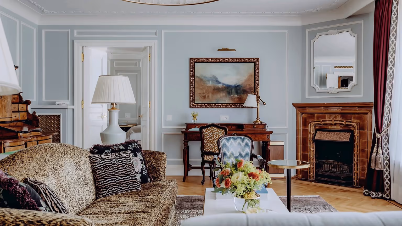 Luxury suite interior at Badrutt’s Palace, St. Moritz, featuring classic European interiors, marble fireplace, and refined alpine elegance.
