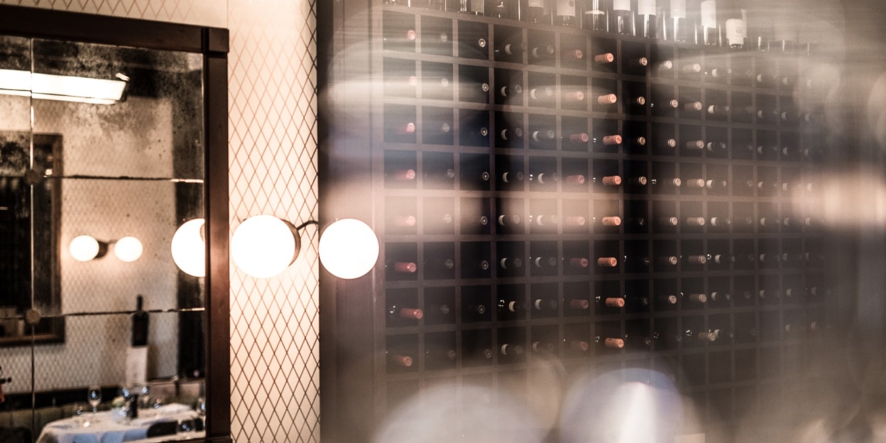 Wall of wine bottles displayed in the dining space at Cantinetta Antinori in Knightsbridge, London.