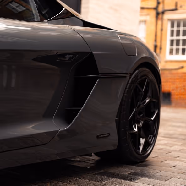 A detailed side-profile shot of the Lamborghini Temerario, focusing on the carbon fiber air scoops and the subtle 'Temerario' badging.