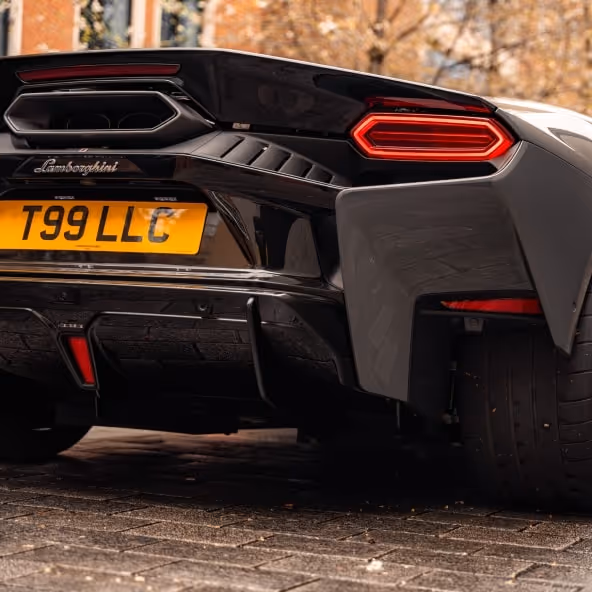 A close-up rear perspective of the Lamborghini Temerario showcasing the hexagonal LED taillights, custom T99 LLC number plate, and wide performance tires.