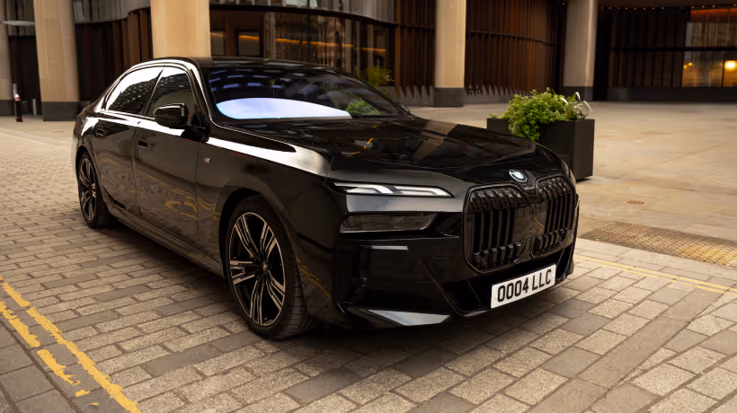 Front angled view of a black BMW 7 Series used for professional chauffeur services.