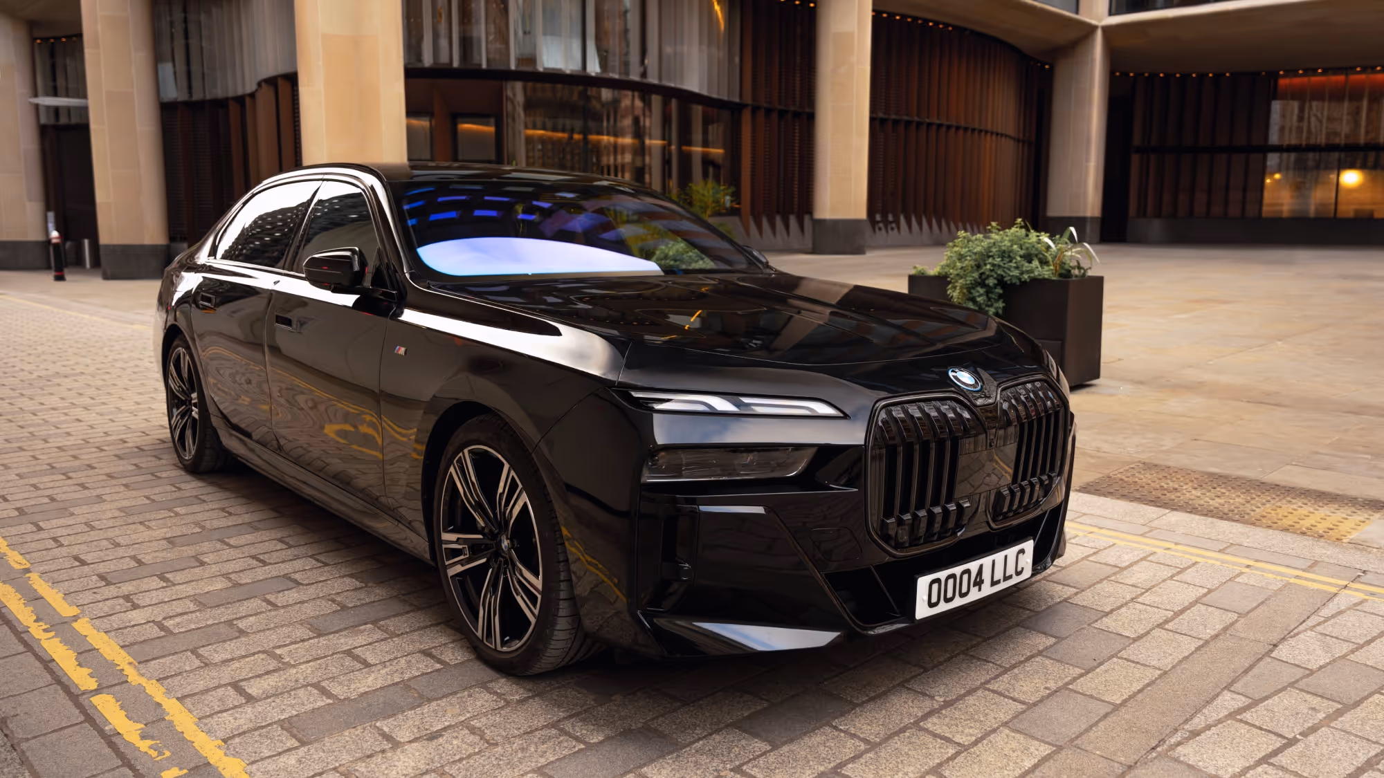 Front angled view of a black BMW 7 Series used for professional chauffeur services.