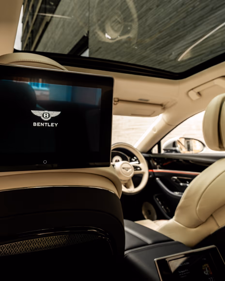 Bentley Flying Spur in London with chauffeur service near a modern city building