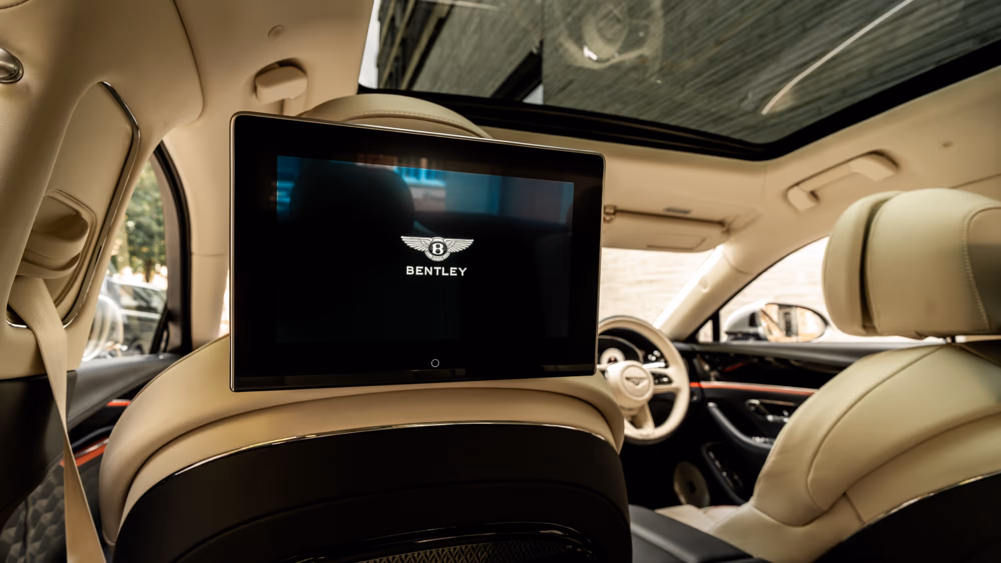 Bentley Flying Spur in London with chauffeur service near a modern city building