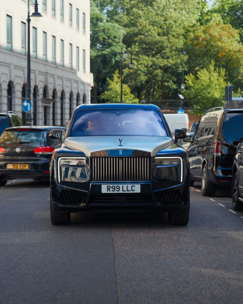 Front view of a Rolls-Royce Cullinan driving through central London, highlighting its commanding presence in city traffic.