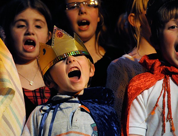 a child dressed as a king in a Nativity pageant