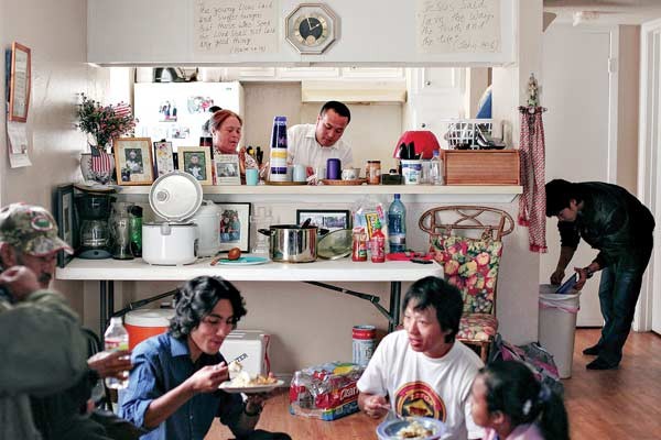 A resident of Austin, Texas, shares a meal with Bhutanese friends.
