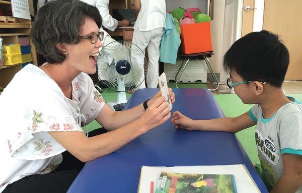 Joy Yoon instructs a child with cerebral palsy.