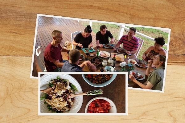 two photos on a wooden table, one of people eating around a picnic table and the other of dishes of food