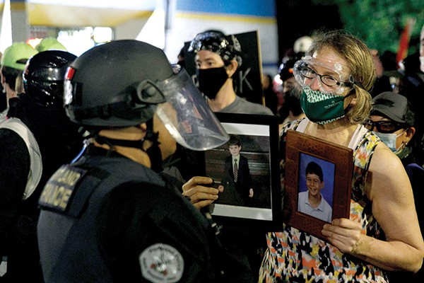 a firs-aid volunteer confronting Portland police, July 2020