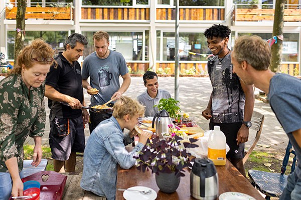 friends gathering at a table outdoors for a meal