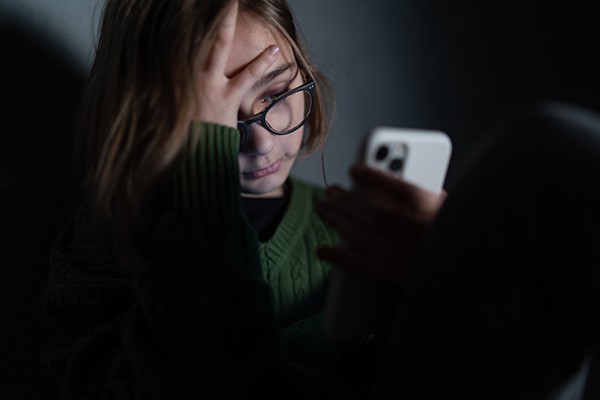 a young girl looking at her phone