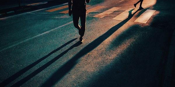 people's shadows on a road