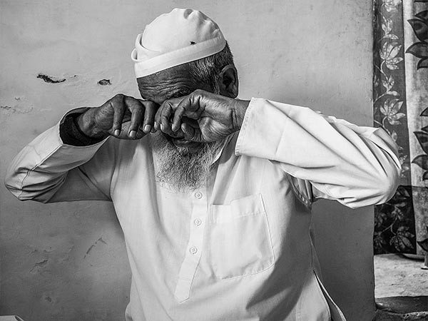 a man covering his eyes