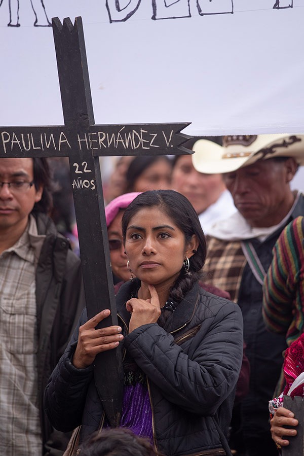 a woman carrying a cross