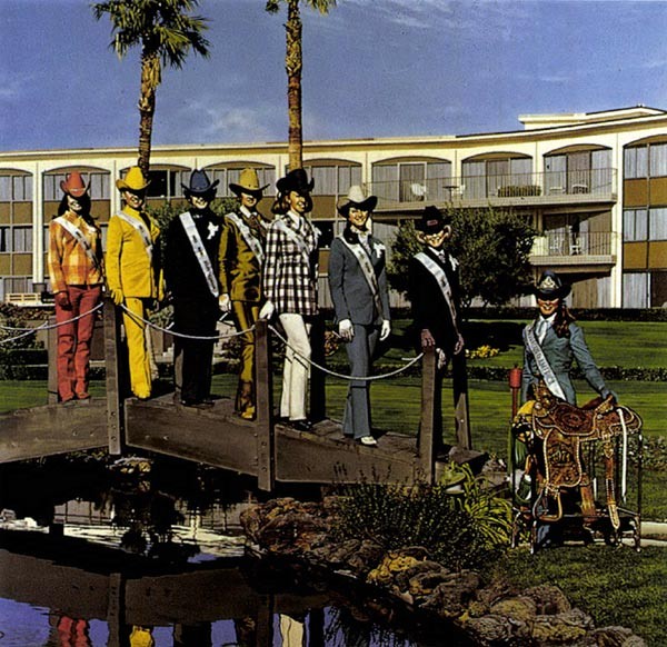 women posing in front of a hotel