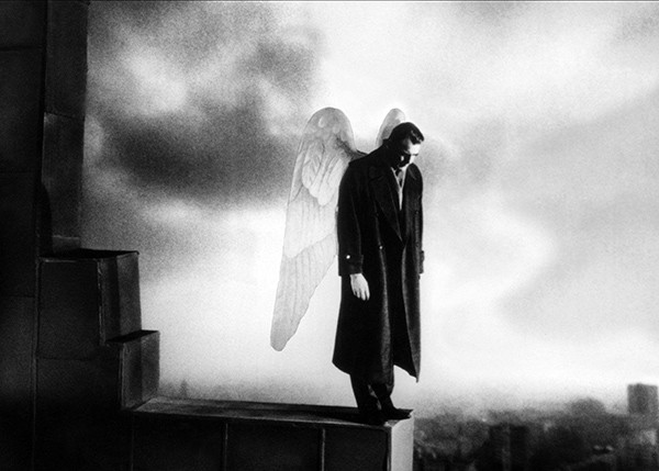 an angel standing above a city