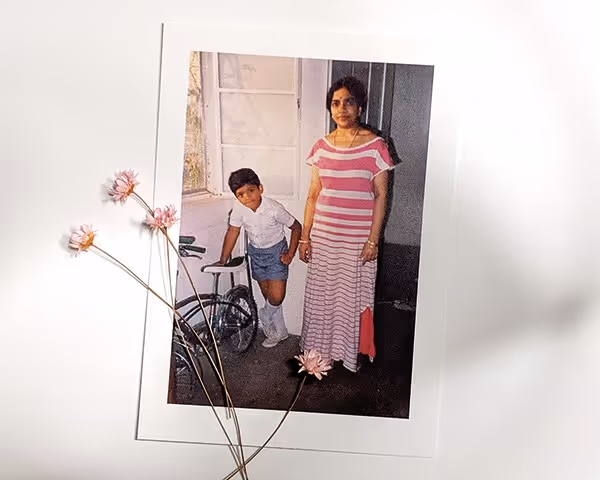 portrait of a boy standing by his mother
